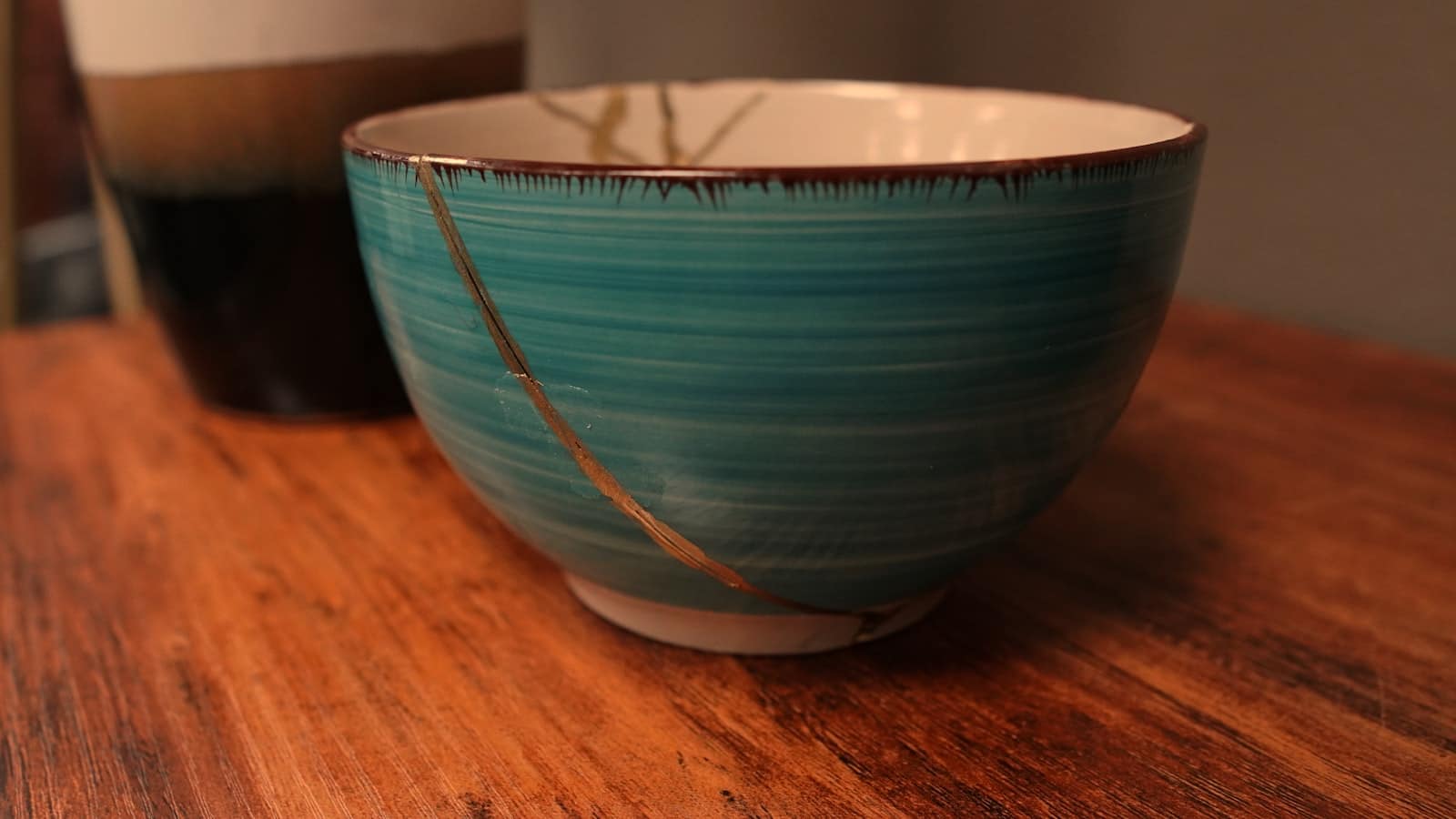 A ceramic bowl mended with veins of gold in the kintsugi tradition